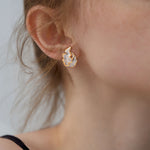 Woman wearing Josefina Studio sea grass earrings, lightweight sterling silver with gold edges, ocean inspired jewelry