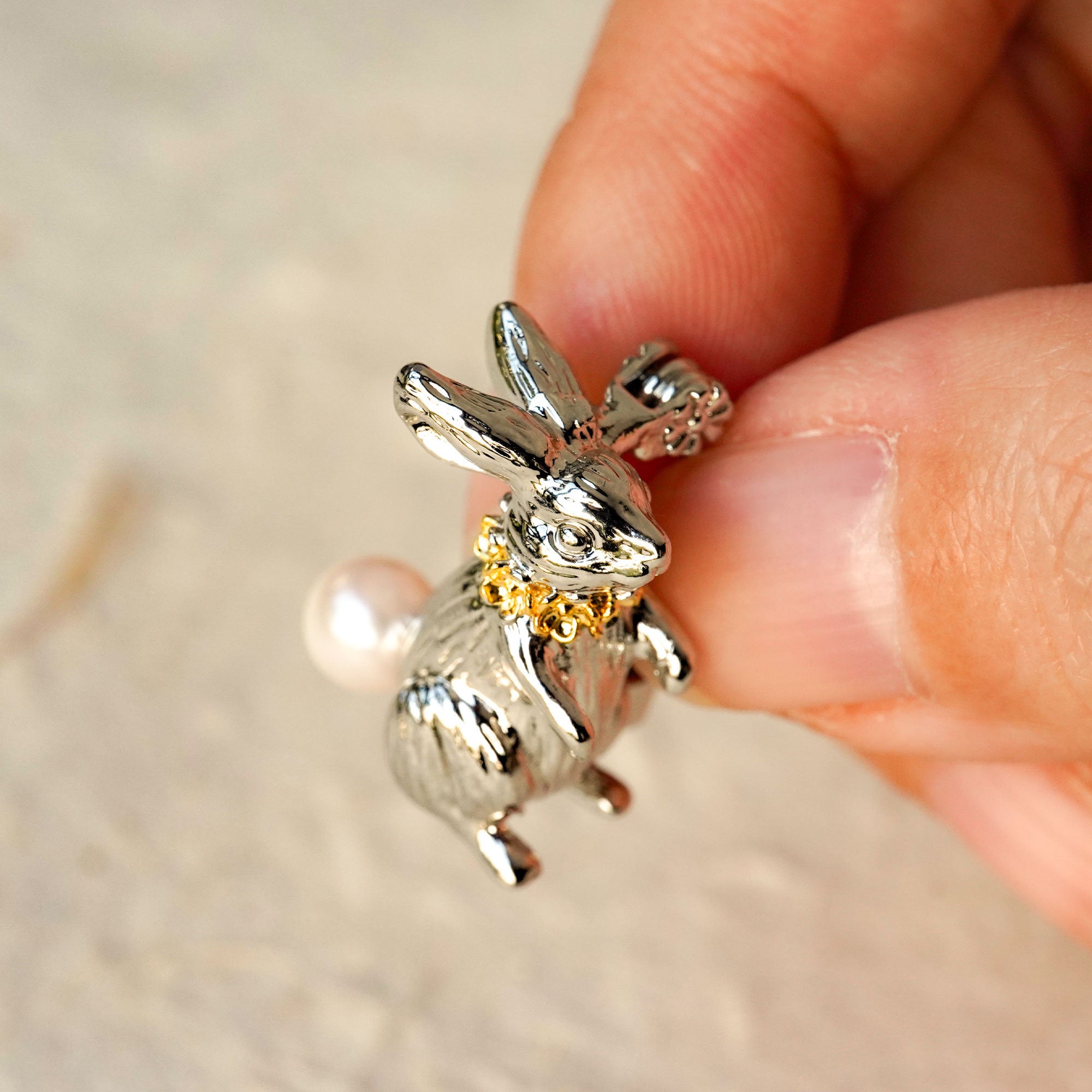 Alice rabbit brooch displayed on neutral background