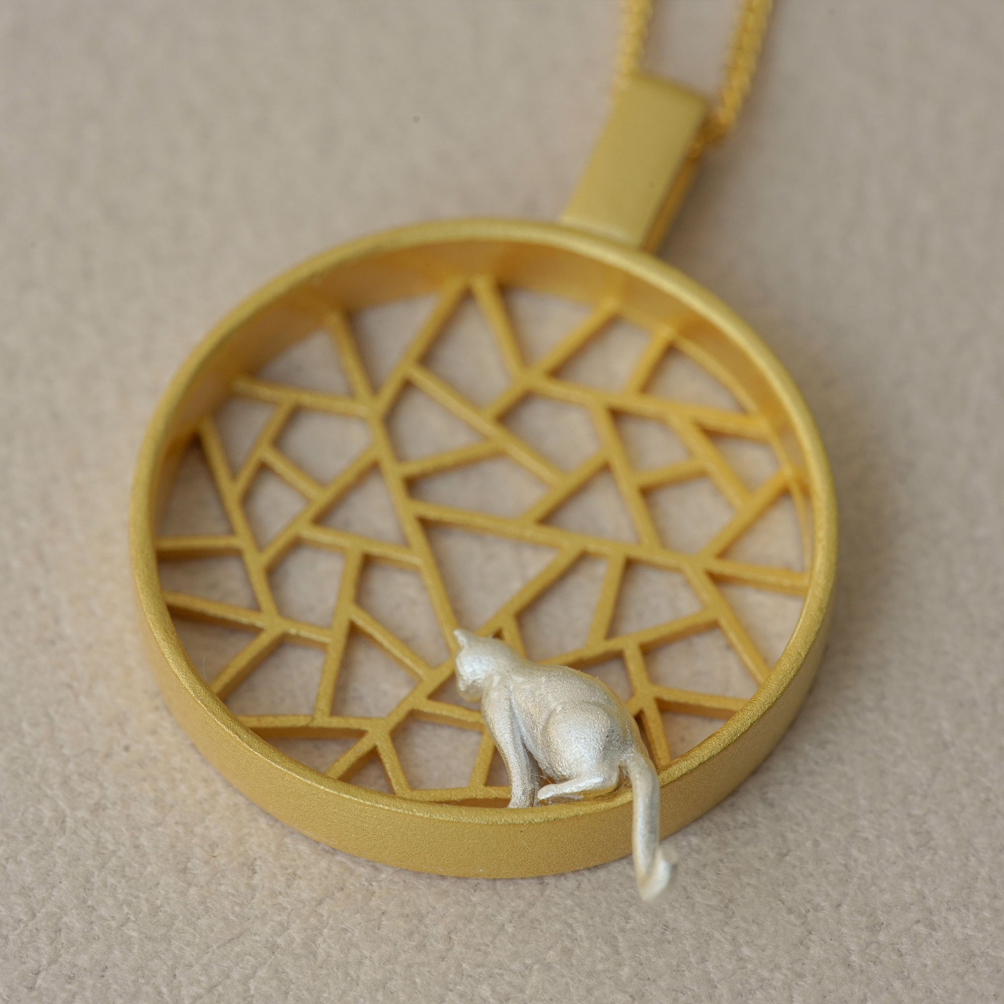 Cat charm necklace showing chain and pendant details
