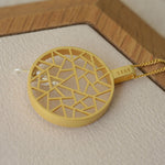 Cat necklace displayed on neutral product background