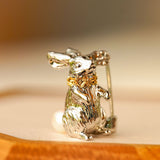 Close-up of Alice rabbit brooch showing character details