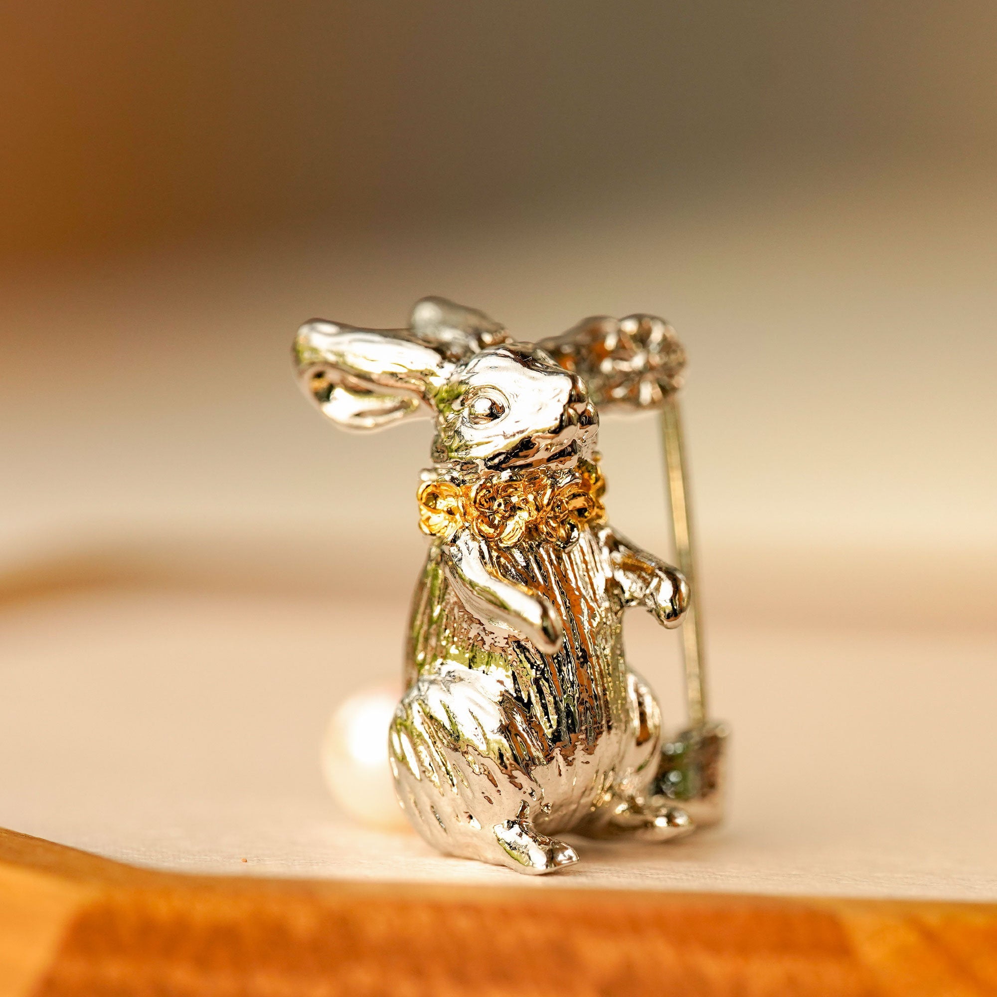 Close-up of Alice rabbit brooch showing character details