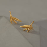 Close-up of bamboo leaf earrings showing leaf details