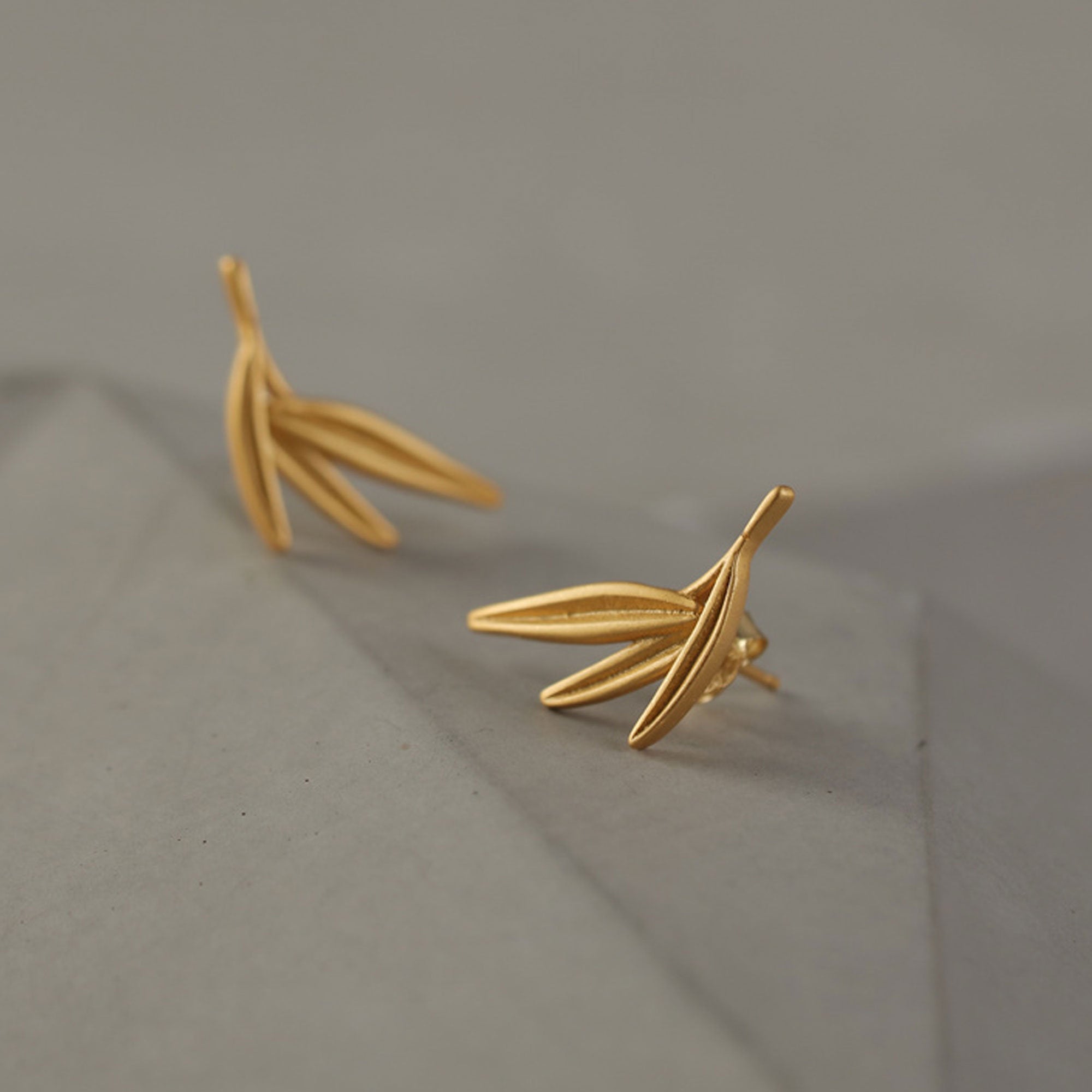 Close-up of bamboo leaf earrings showing leaf details
