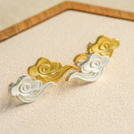 Close-up of cloud earrings showing curved shape