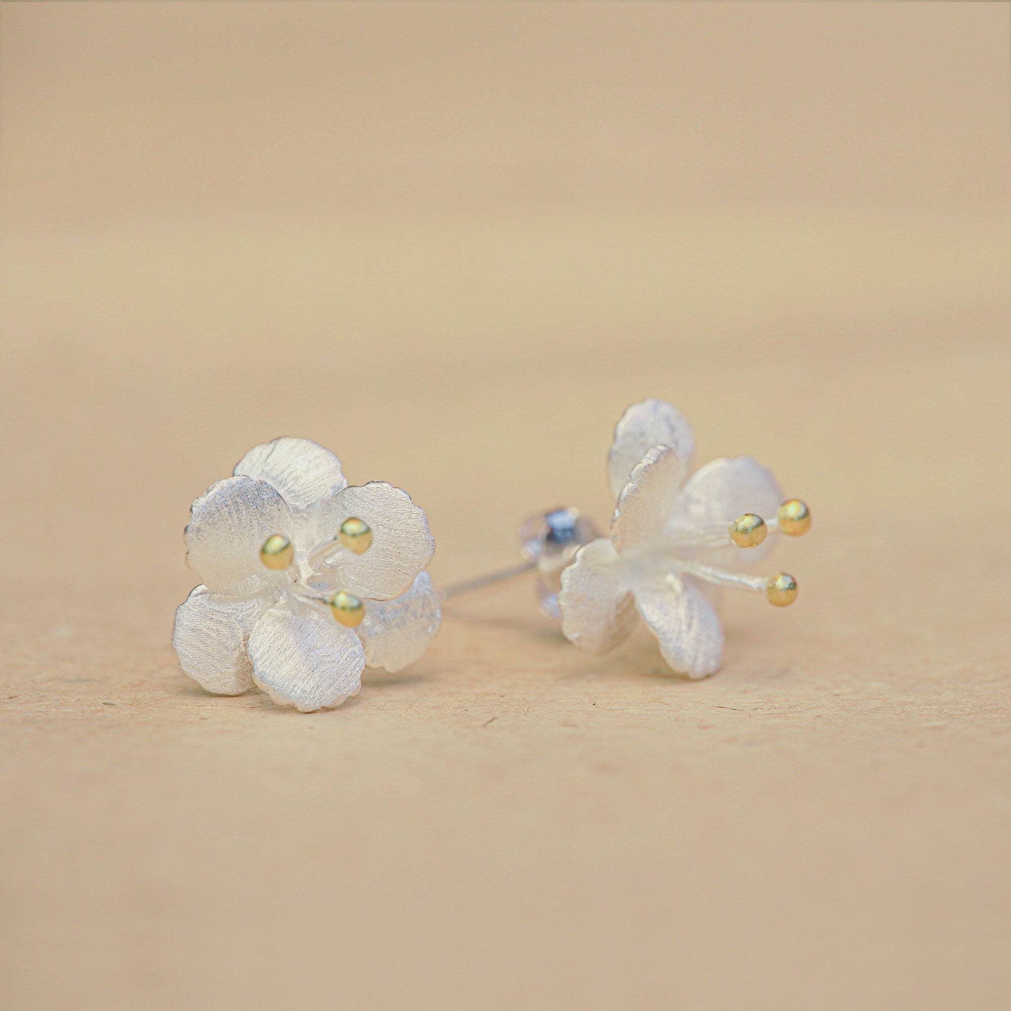 Close-up of crab apple flower earrings showing petal details