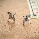 Close-up of crane bird stud earrings
