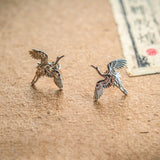 Close-up of crane bird stud earrings