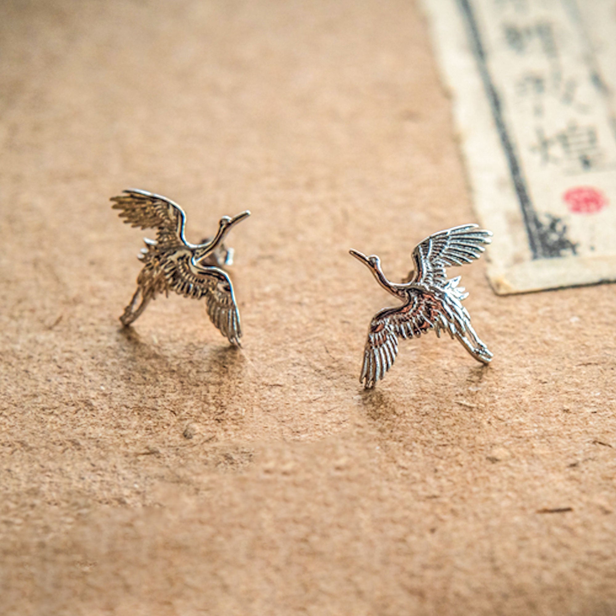 Close-up of crane bird stud earrings