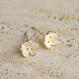 Close-up of flower stud earrings showing petal details