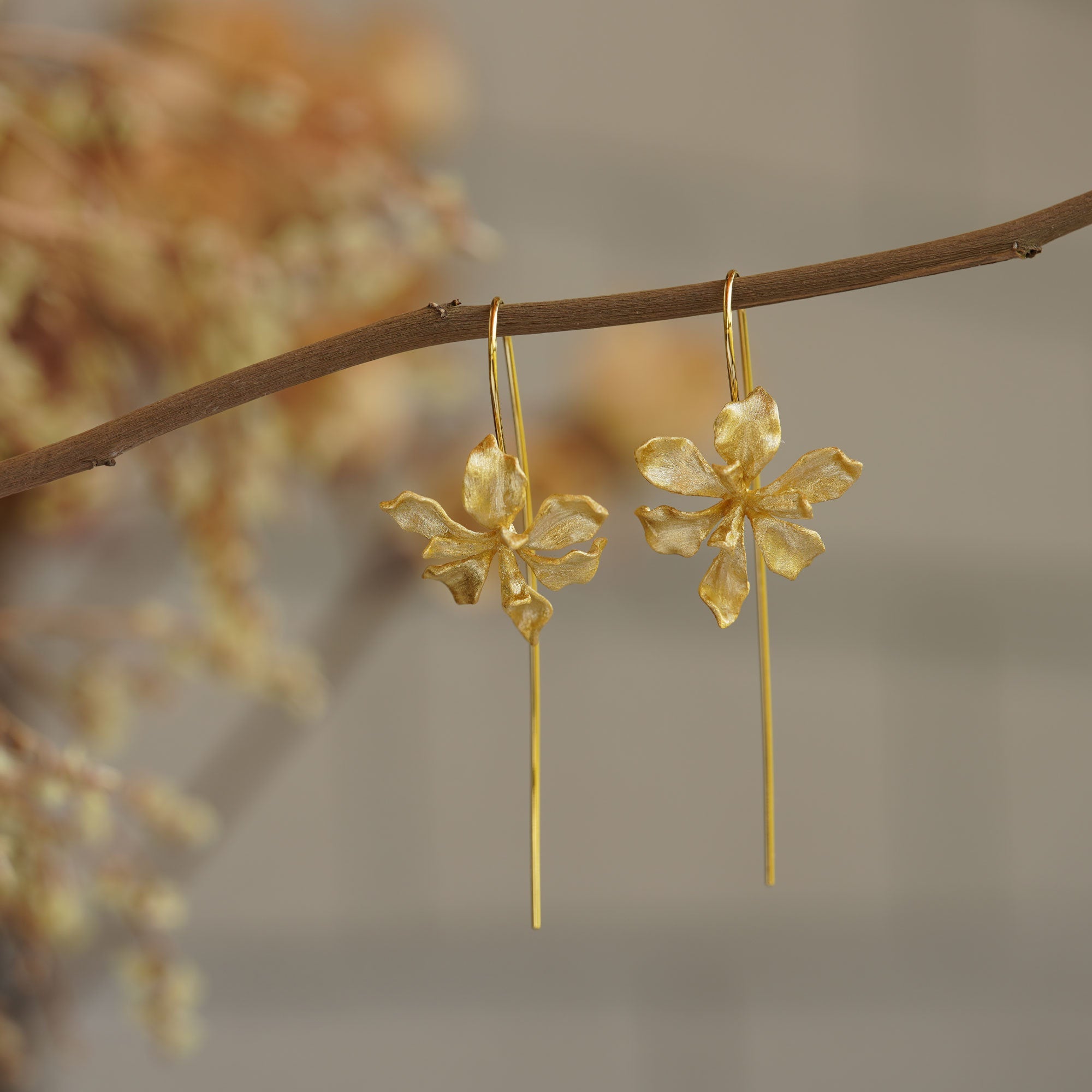 Close-up of iris flower drop earrings showing petal details