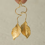 Close-up of leaf dangle earrings showing vein details