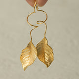 Close-up of leaf dangle earrings showing vein details
