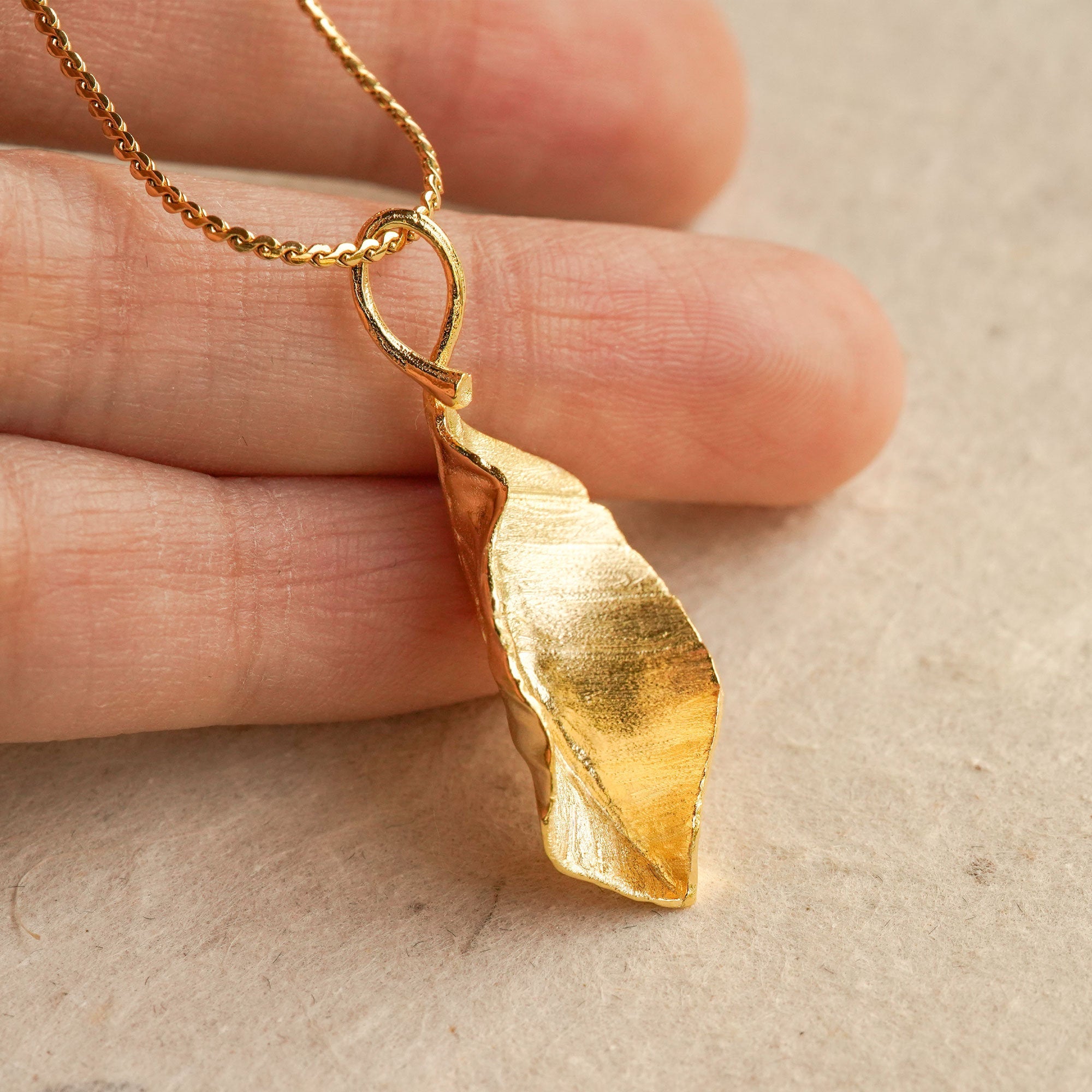 Close-up of leaf necklace pendant showing vein details