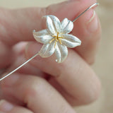 Close-up of lily drop earrings showing petal details