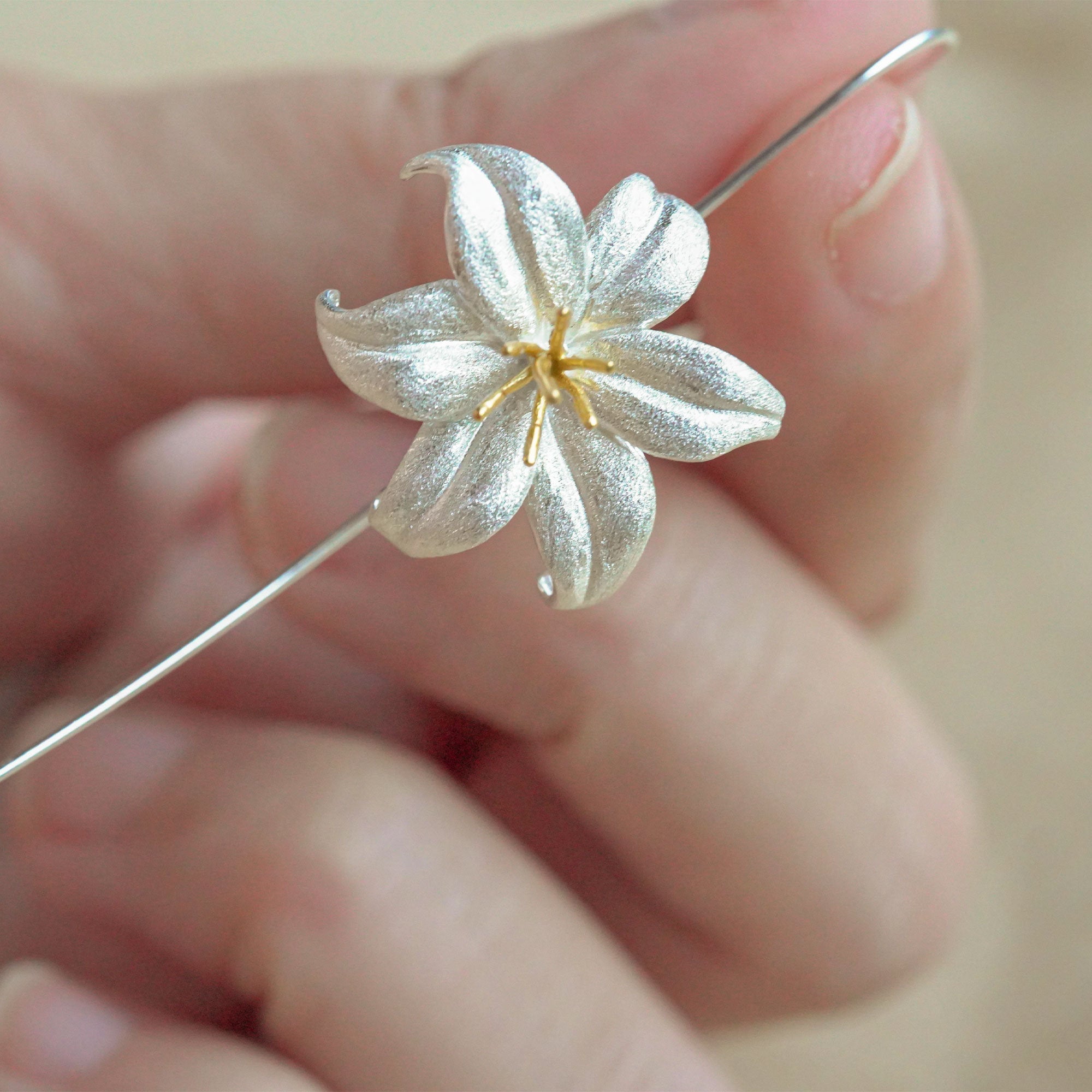 Close-up of lily drop earrings showing petal details