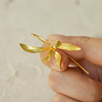 Close-up of orchid earrings showing floral details