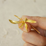 Close-up of orchid earrings showing floral details