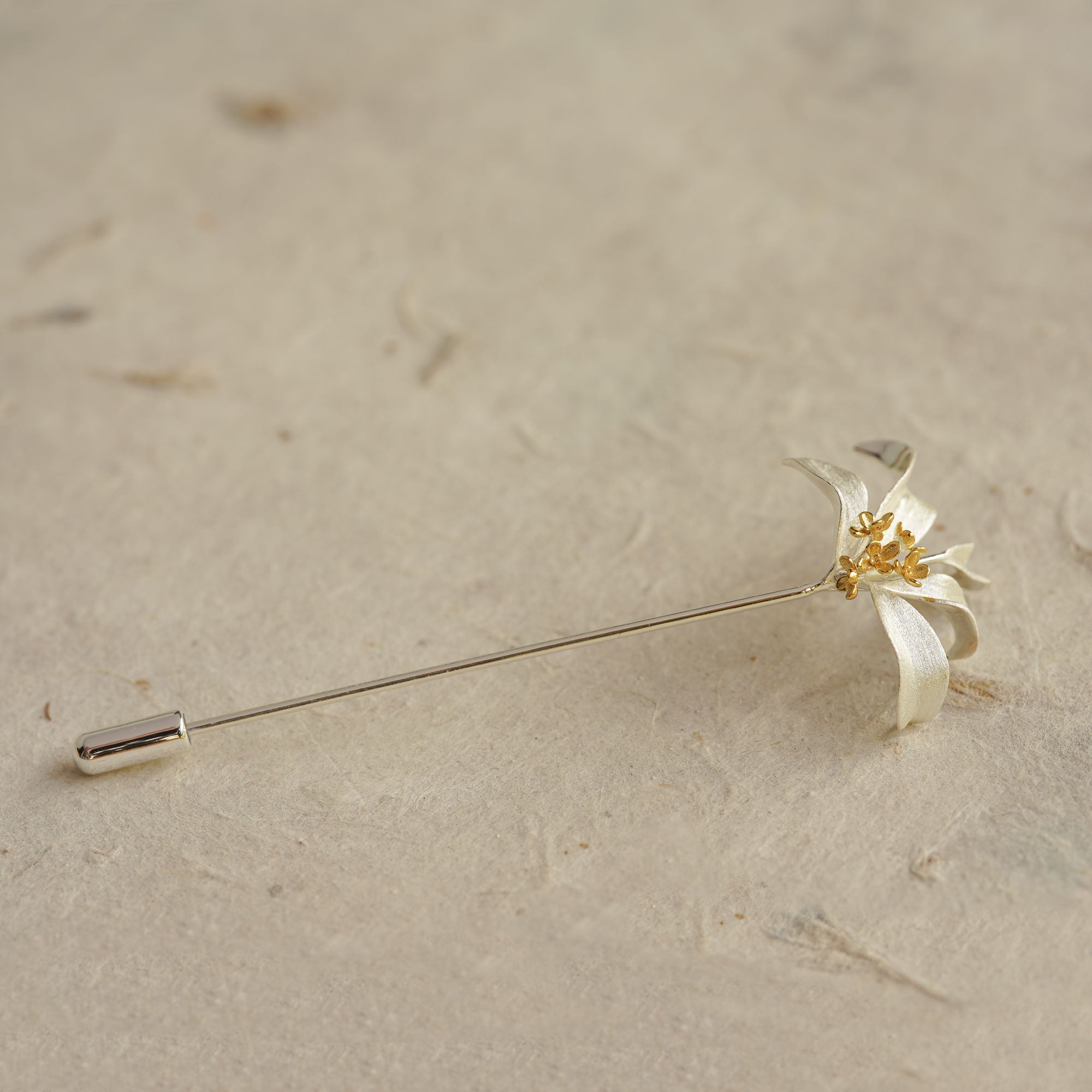Close-up of osmanthus brooch showing blossom details