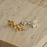 Close-up of osmanthus flower earrings showing petal details