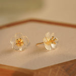 Close-up of pear flower earrings showing petals