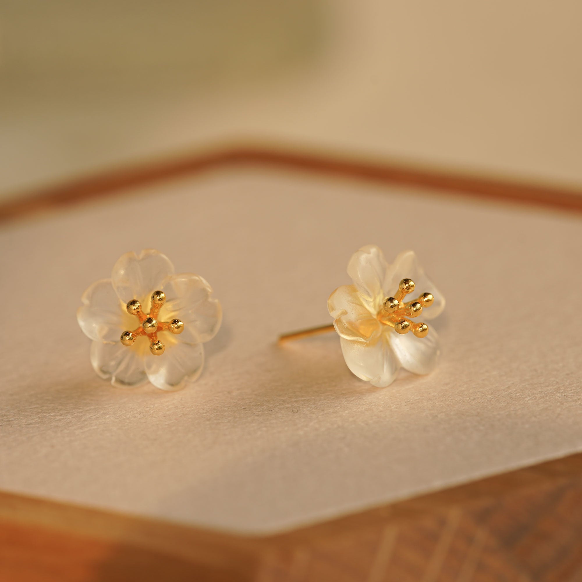 Close-up of pear flower earrings showing petals