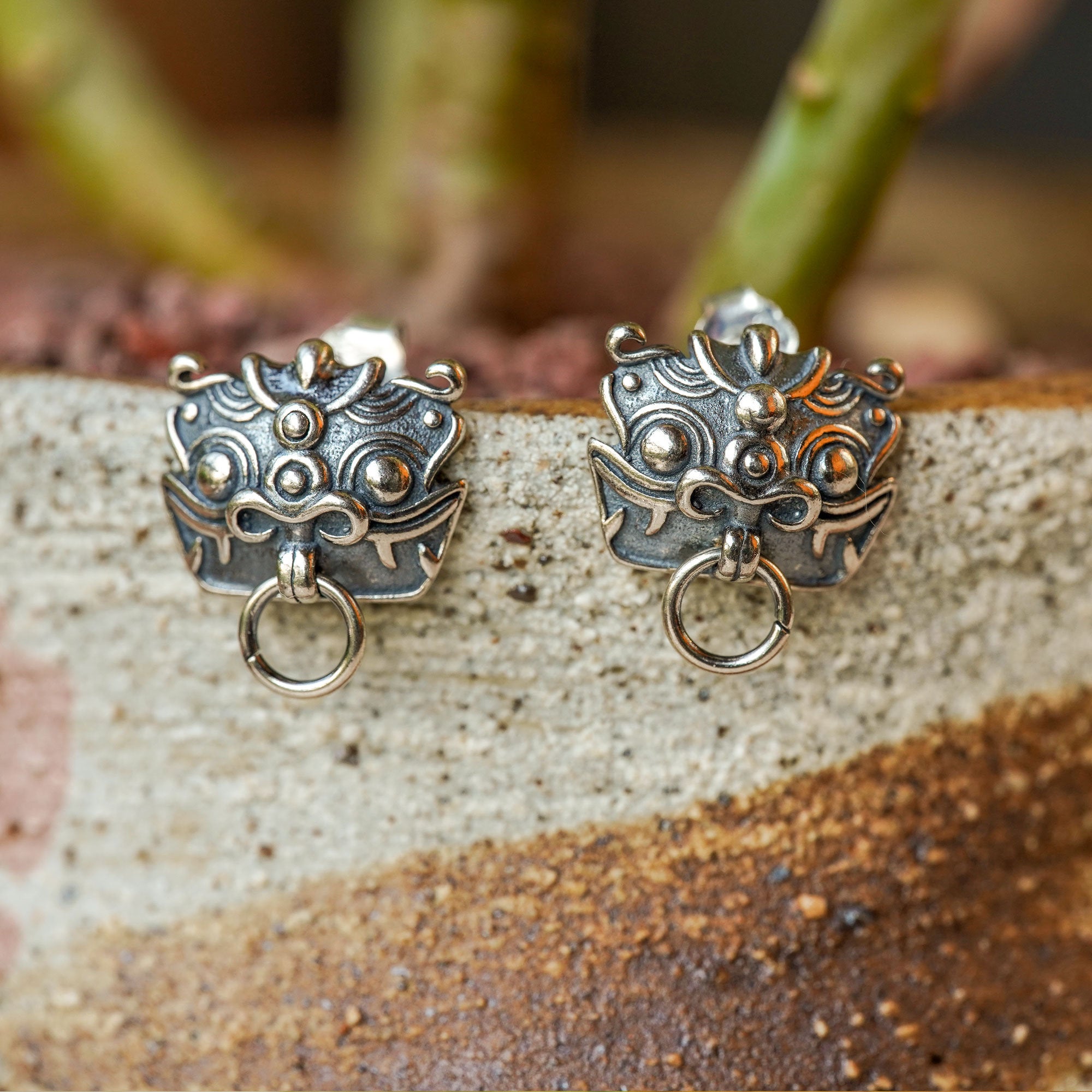 Close-up of pixiu earrings showing sculpted details