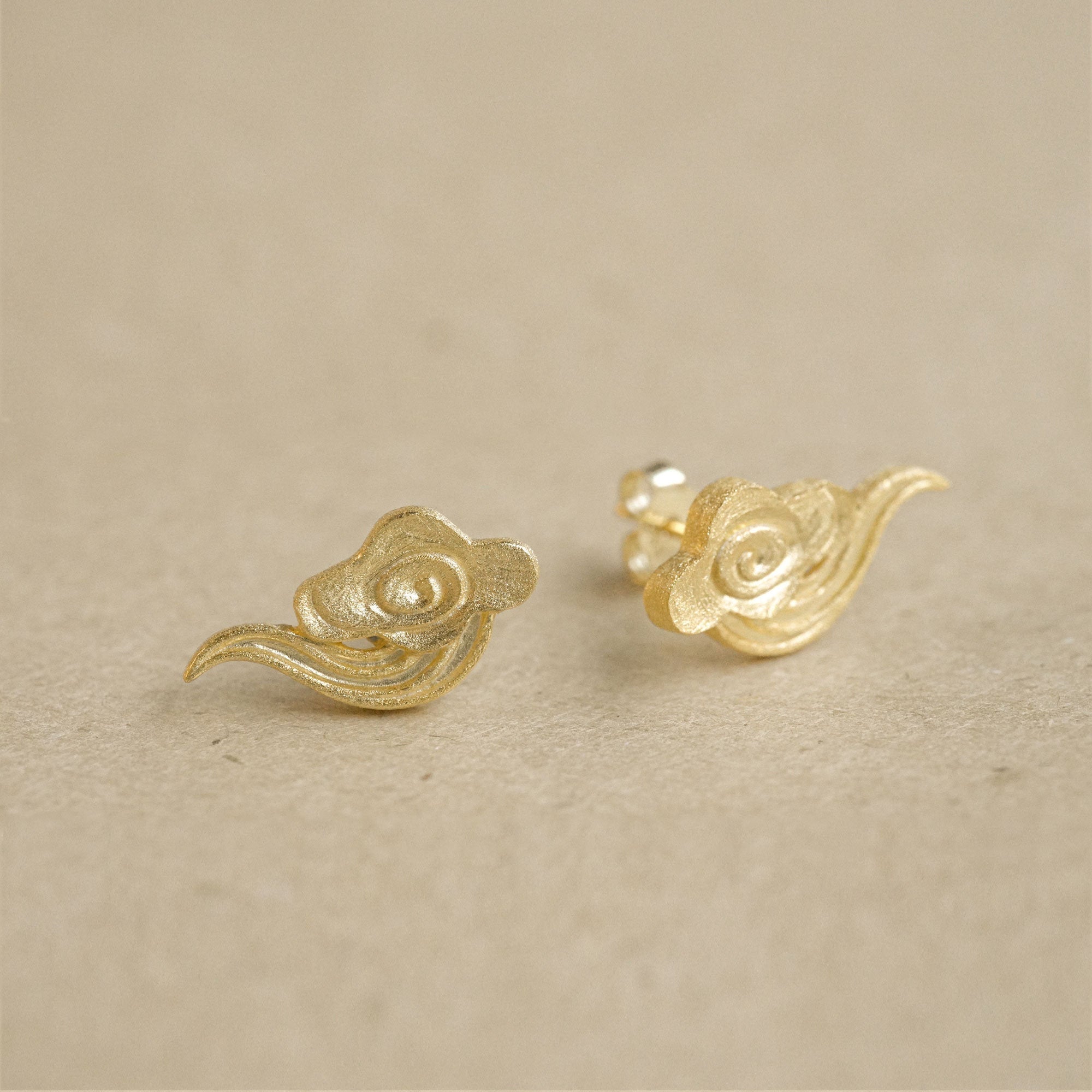 Cloud earrings showing handmade jewelry details