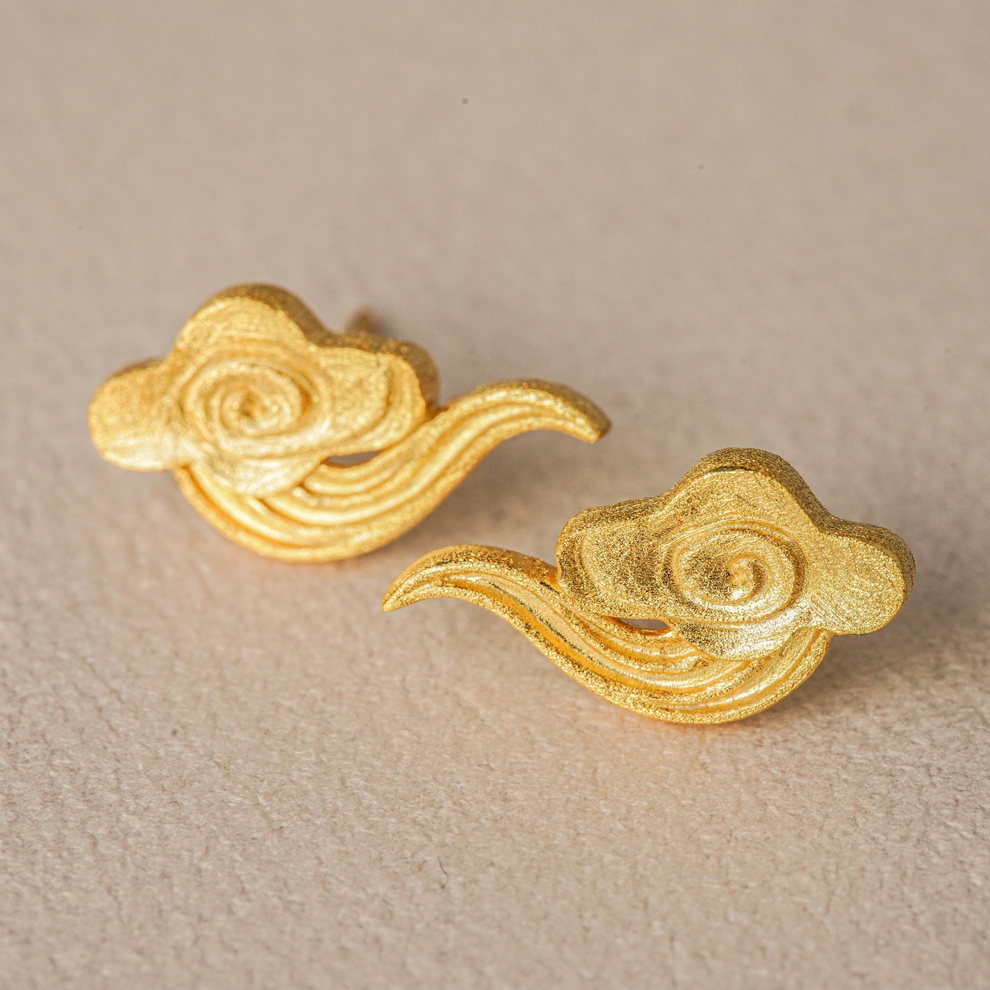 Cloud earrings on a neutral product background