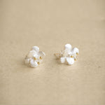 Crab apple flower earrings on a neutral product background