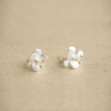 Crab apple flower earrings on a neutral product background