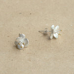 Crab apple flower earrings displayed as a pair