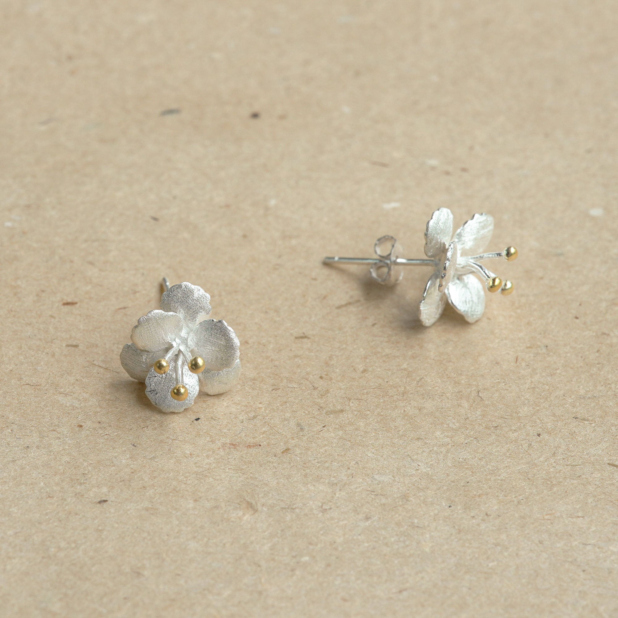 Crab apple flower earrings displayed as a pair