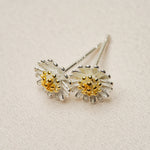 Daisy earrings displayed as a pair