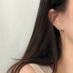 Detailed view of crane bird stud earrings