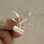 Detailed view of daffodils brooch