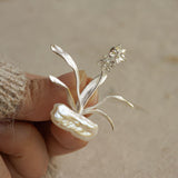 Detailed view of daffodils brooch