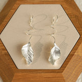 Detailed view of leaf dangle earrings
