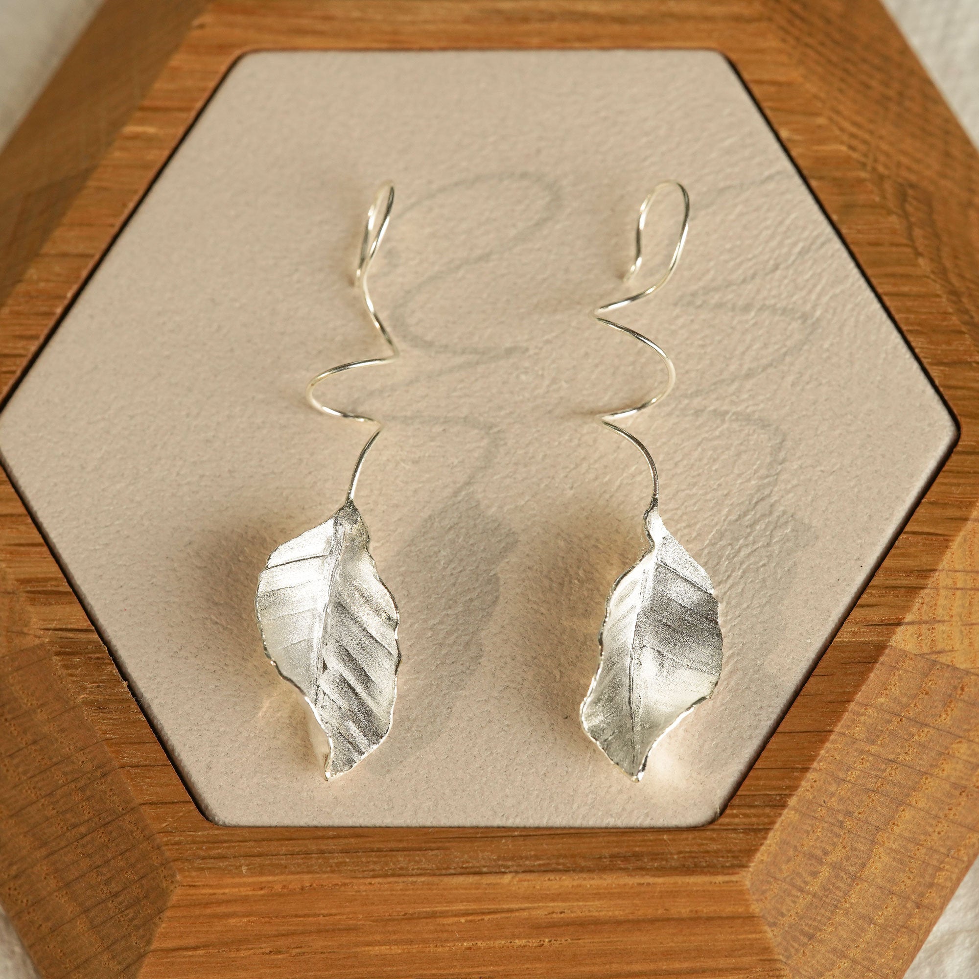 Detailed view of leaf dangle earrings