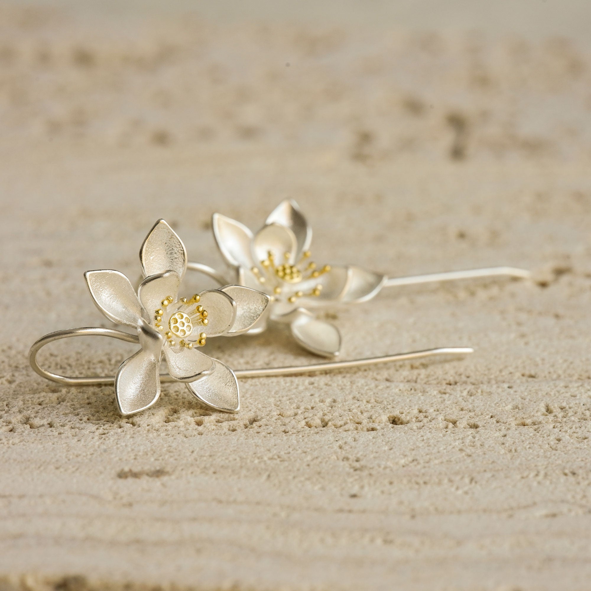 Detailed view of lotus flower dangling earrings