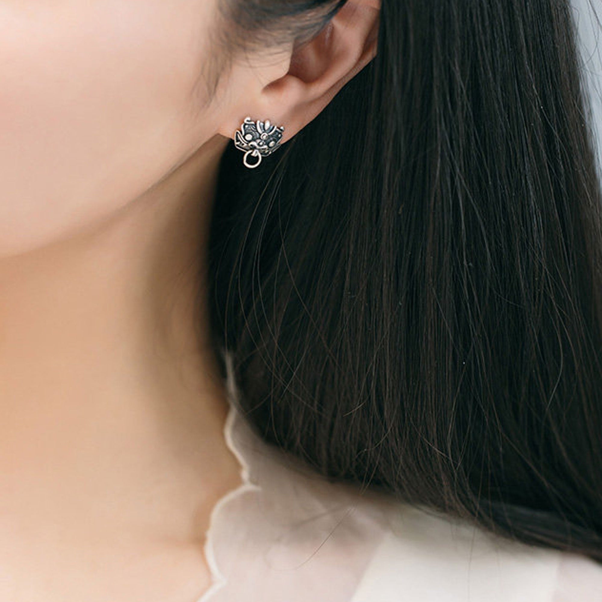 Detailed view of pixiu earrings