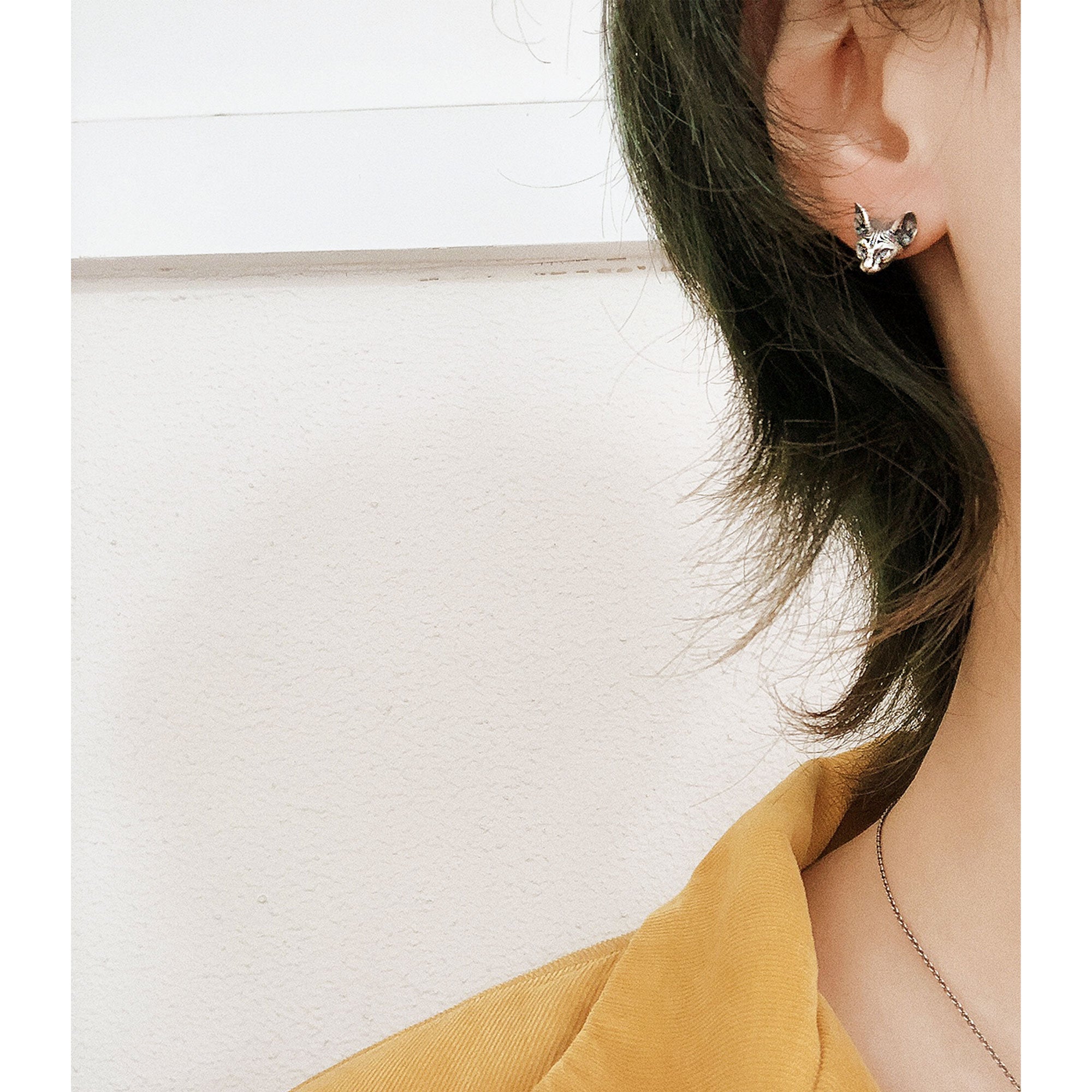 Detailed view of sphinx cat earrings