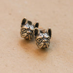 French bulldog earrings on a neutral product background