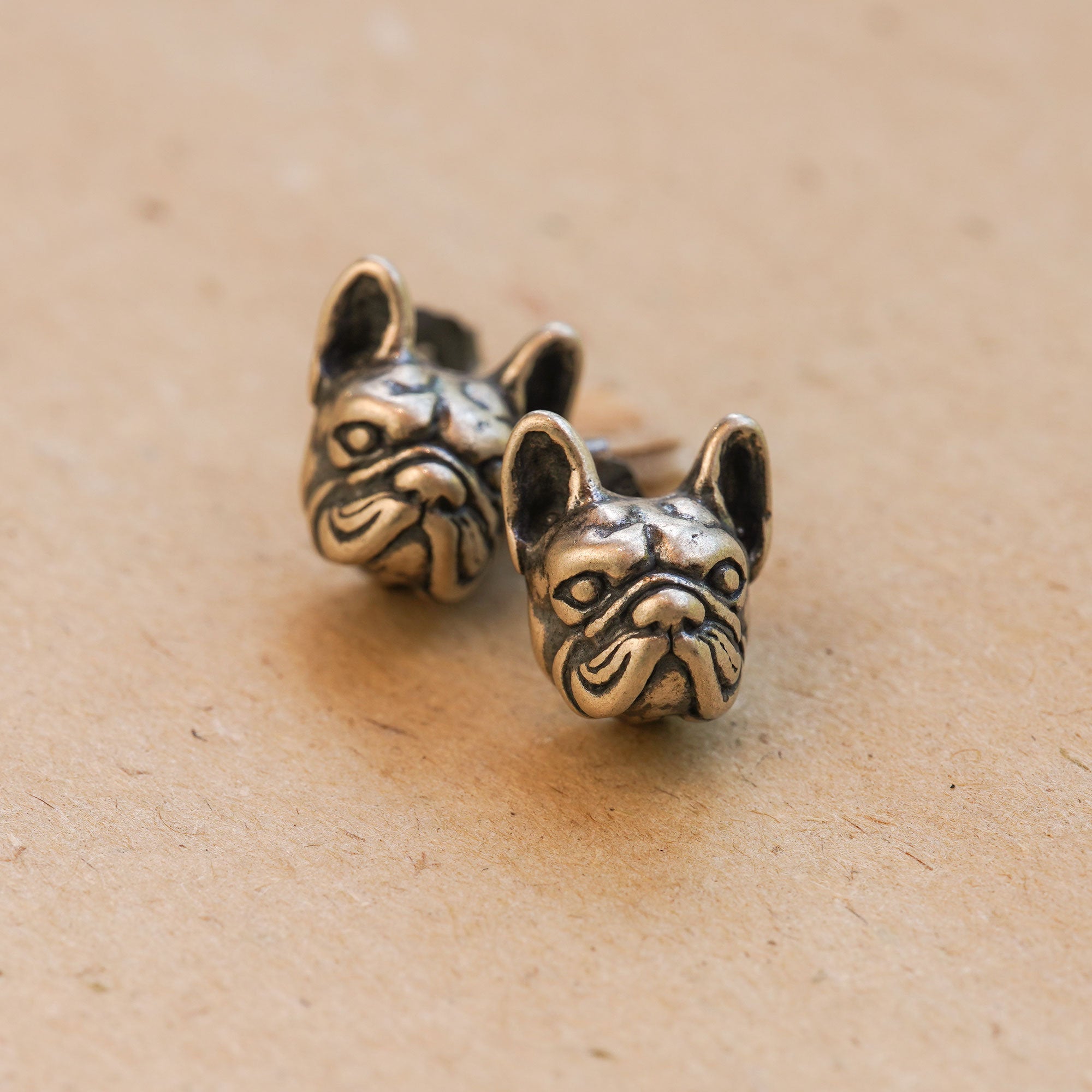 French bulldog earrings on a neutral product background