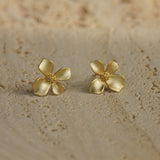 Gardenia earrings on a neutral product background