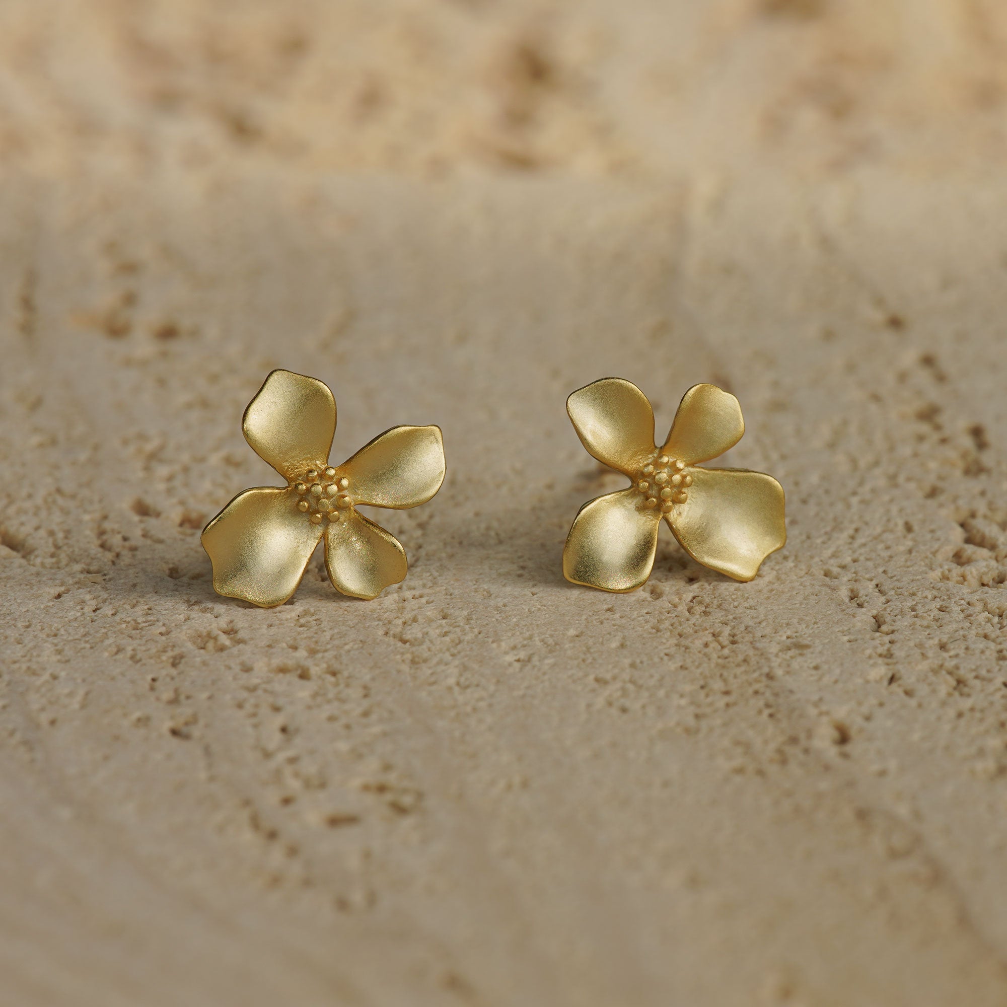 Gardenia earrings on a neutral product background