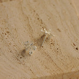 Iris earrings styled as botanical stud jewelry