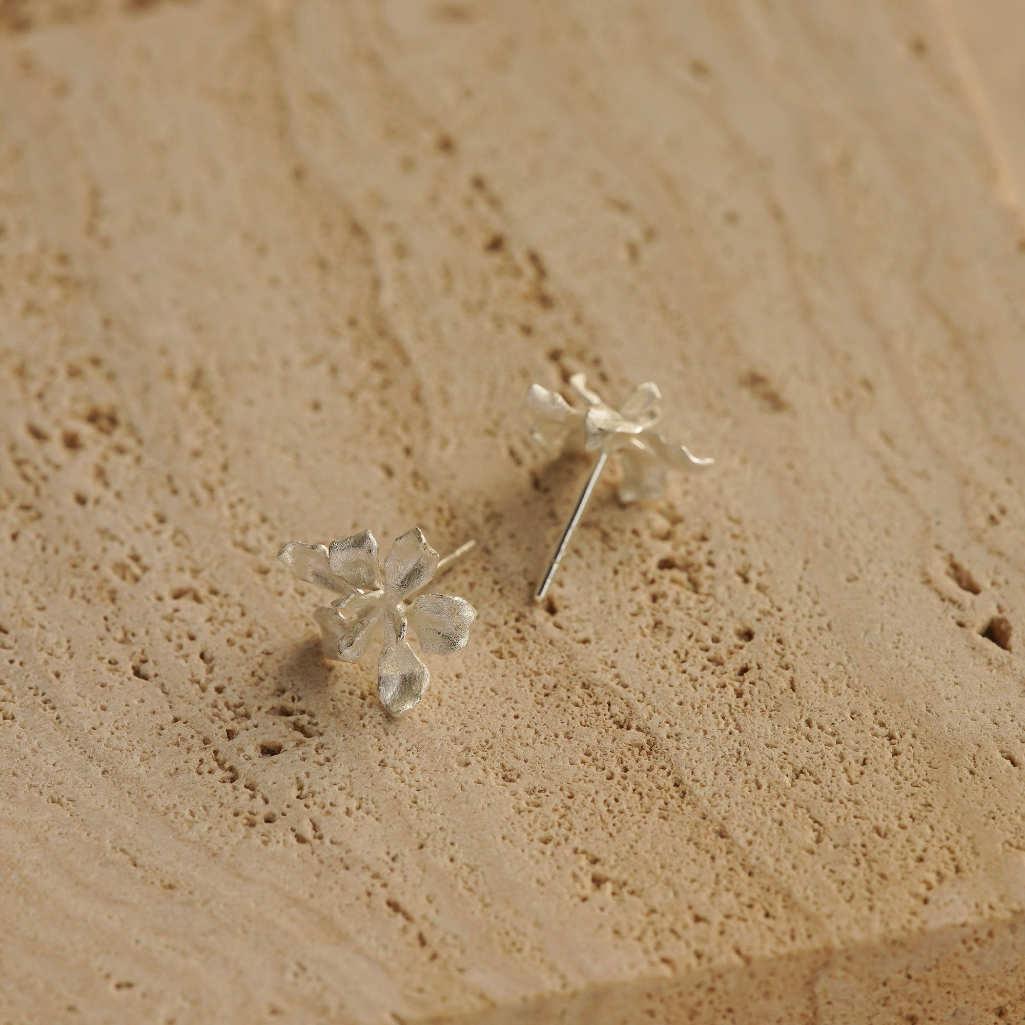 Iris earrings styled as botanical stud jewelry