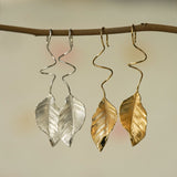 Leaf dangle earrings styled as botanical jewelry