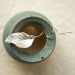 Leaf dangle earrings showing handmade jewelry details